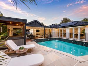 an image of a swimming pool in a house at Peaceful tropical retreat with pool, mineral spa & Games room in Gold Coast