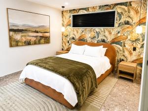 a bedroom with a bed and a wall mural at Peaceful tropical retreat with pool, mineral spa & Games room in Gold Coast +46 photos