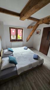 a bedroom with a large bed with blue pillows at Pokoje Gościnne w Spichlerzu in Ustka +21 photos