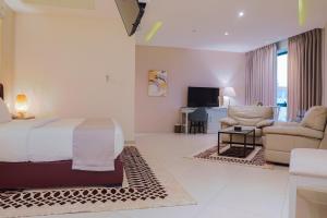a bedroom with a bed and a living room at Amman West Hotel , A Boutique Hotel in Amman