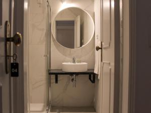 a bathroom with a sink and a mirror at Hotel Jardim in Coimbra +35 photos