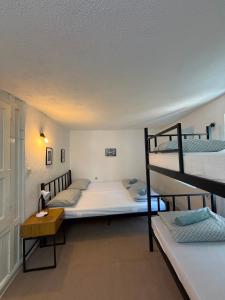 a bedroom with two bunk beds and a desk at Bajatova Heritage House with Private Courtyard in Mostar