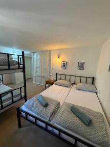 a bedroom with two beds and a bunk bed at Bajatova Heritage House with Private Courtyard in Mostar