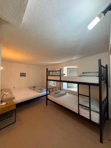 two bunk beds in a room with a ceiling at Bajatova Heritage House with Private Courtyard in Mostar