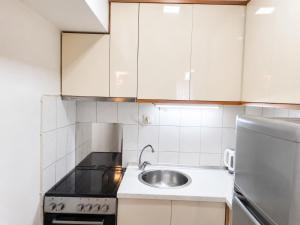 a small kitchen with a sink and a refrigerator at Apartment 88 SELF check-in, FREE parking in Skopje +22 photos
