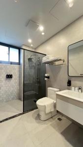 a bathroom with a shower and a toilet and a sink at 台東靜巷19號民宿編號1901 in Taitung City +58 photos