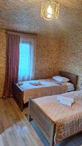 a bedroom with two beds and a window at Sarag in Ushguli