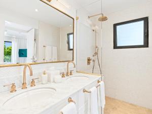 a bathroom with a sink and a large mirror at La Sirène in Simpson Bay +44 photos