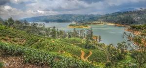 a view of a large river with a mountain at Madhusha Rest in Maskeliya