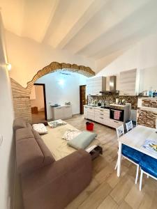 a living room with a couch and a table at Casale di Torvaianica in Campo Iemini