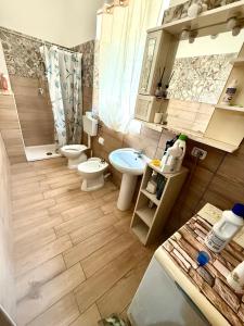 a small bathroom with two toilets and a sink at Casale di Torvaianica in Campo Iemini +43 photos
