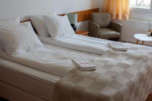 a large bed with two towels on top of it at Hotel Leirubakki in Hella +24 photos