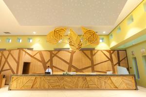 a man standing in a lobby with a reception desk at Blue Lagoon Resort in Lampi +62 photos