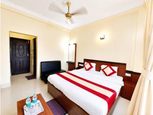 a bedroom with a large bed and a black door at The Annapurna Resort Hotel & Restaurant - Walking From 100m From Sea Beach, Free Wifi, Parking Available ! Luxury & Best Hotel in Puri in Puri