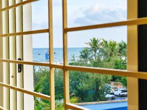 a view from a window of the beach at The Annapurna Resort Hotel & Restaurant - Walking From 100m From Sea Beach, Free Wifi, Parking Available ! Luxury & Best Hotel in Puri in Puri