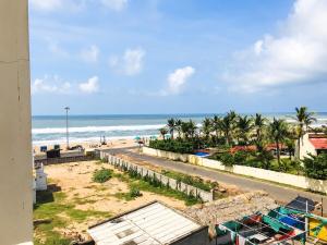 a view of the beach from the balcony of a condo at The Annapurna Resort Hotel & Restaurant - Walking From 100m From Sea Beach, Free Wifi, Parking Available ! Luxury & Best Hotel in Puri in Puri +11 photos