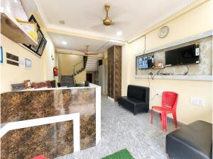 a living room with a bar and a red chair at The Annapurna Resort Hotel & Restaurant - Walking From 100m From Sea Beach, Free Wifi, Parking Available ! Luxury & Best Hotel in Puri in Puri
