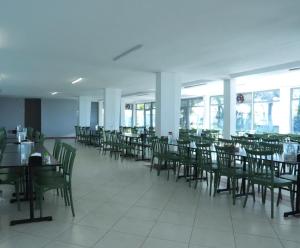 a dining room with tables and chairs and windows at Karev Sport Hotel in Gümüşyaka +26 photos