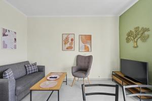 a living room with a couch and a tv at Kallichoron 3 fortezza Kavala in Kavála
