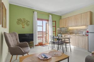 a kitchen and living room with a table and chairs at Kallichoron 3 fortezza Kavala in Kavála