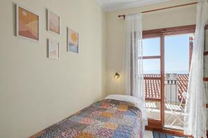 a bedroom with a bed and a window with a view at Kallichoron 3 fortezza Kavala in Kavála