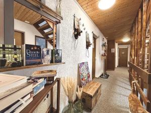 a hallway of a building with a table with a skateboard at Hôtel Restaurant Les Cernets, "Val-de-Travers" in Les Verrières