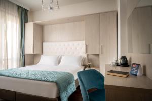 a bedroom with a white bed with a blue blanket at Re Enzo in Bologna +61 photos