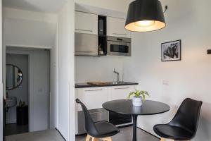 a kitchen with a table and chairs in a room at The Como Pet Nest in Laglio