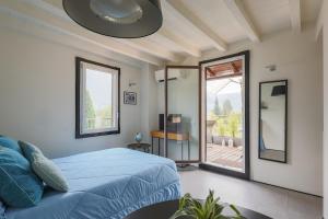a bedroom with a bed and a sliding glass door at The Como Pet Nest in Laglio