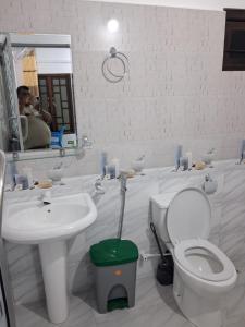 a bathroom with a toilet and a sink and a mirror at Beach Life Long Beach Resort in Trincomalee
