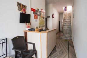 a office with a desk and a chair in a room at Good Karma B&B in Khajurāho