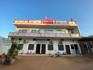 a building with a red sign on top of it at Good Karma B&B in Khajurāho