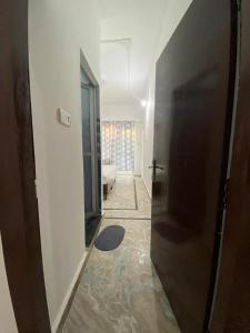 a hallway with a door leading to a living room at Good Karma B&B in Khajurāho