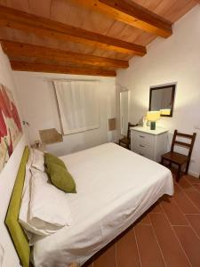 a bedroom with a large white bed and a desk at Country house La Virgy with exclusive pool and sea view in Avola