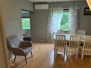 a dining room with a table and chairs and a window at Wooden House 2 bedrooms in Turku