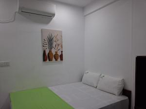 a room with a bed and a picture on the wall at Beach Life Long Beach Resort in Trincomalee
