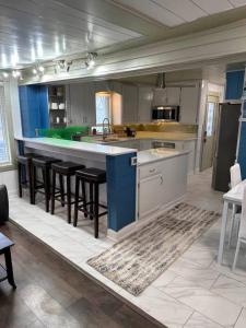 a large kitchen with a large island with bar stools at Hot Tub 5 beds in Moorhead