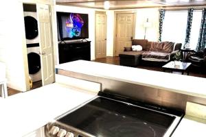 a living room with a couch and a tv at Hot Tub 5 beds in Moorhead