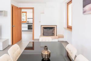 a dining room with a table and a fireplace at Villa Sonia in Bardolino