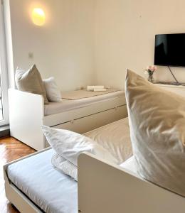 a bedroom with a bed and a couch with pillows at Falcon in Mali Lošinj