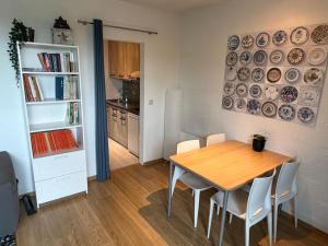 a dining room with a table and some plates on the wall at Le Papillon in Hotton