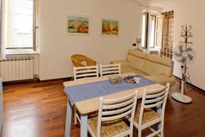 a living room with a table and chairs and a couch at Casa Ada in Muggia