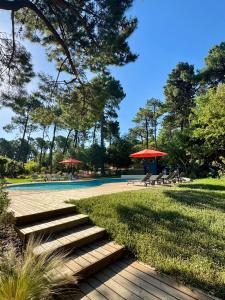 a group of stairs and umbrellas in a park at N&L Signature - Ô Lodge in Mornas