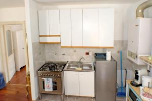 a kitchen with a stove and a sink at Casa Ada in Muggia