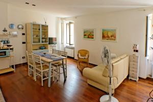 a kitchen and dining room with a table and chairs at Casa Ada in Muggia +11 photos