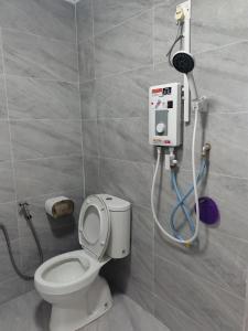 a bathroom with a toilet and a shower at Aimers Lodge in Dungun +111 photos
