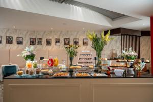 a buffet line with food and desserts on display at Re Enzo in Bologna