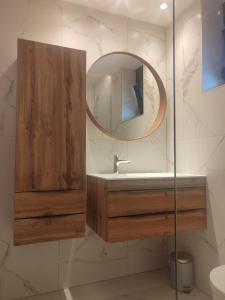 a bathroom with a sink and a mirror at Apartments DiVi Sunset View in Mandre +55 photos