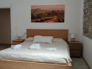 a bedroom with a bed with two towels on it at Albizi Home in Pontassieve