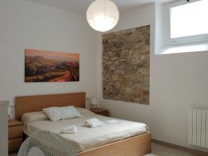 a bedroom with a bed and a painting on the wall at Albizi Home in Pontassieve